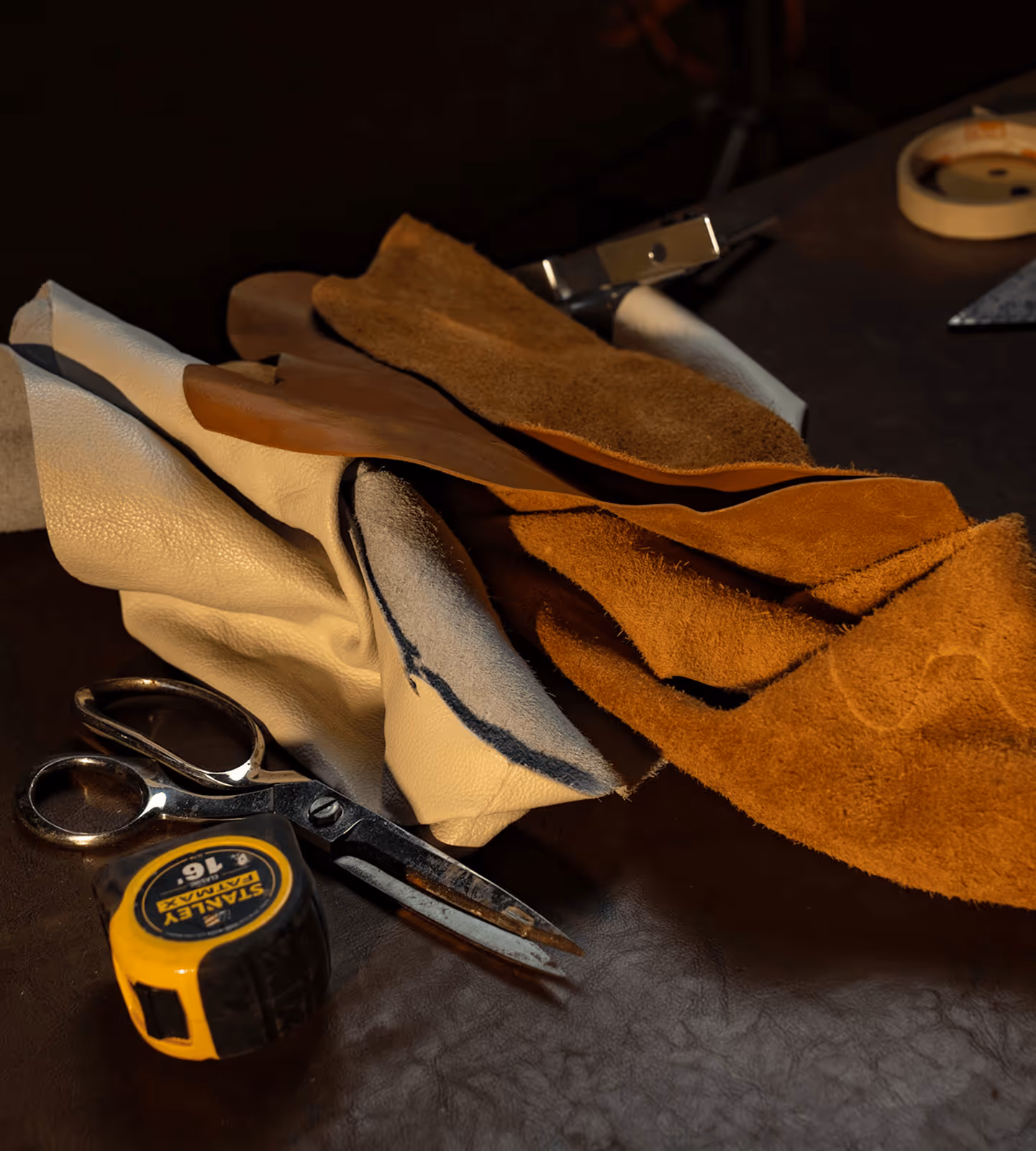 Leather swatches, measuring tools, and upholstery supplies
